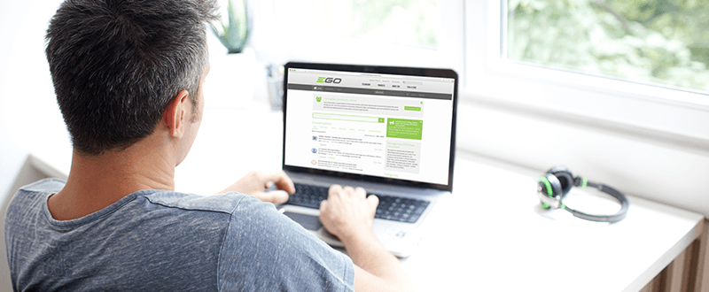 A man looking at the EGO community forum on his laptop.